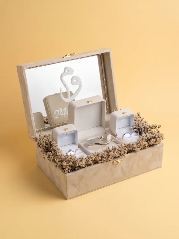 Box rings wedding: open bracelet box with bangle between two lit ring boxes, mirror and monogram