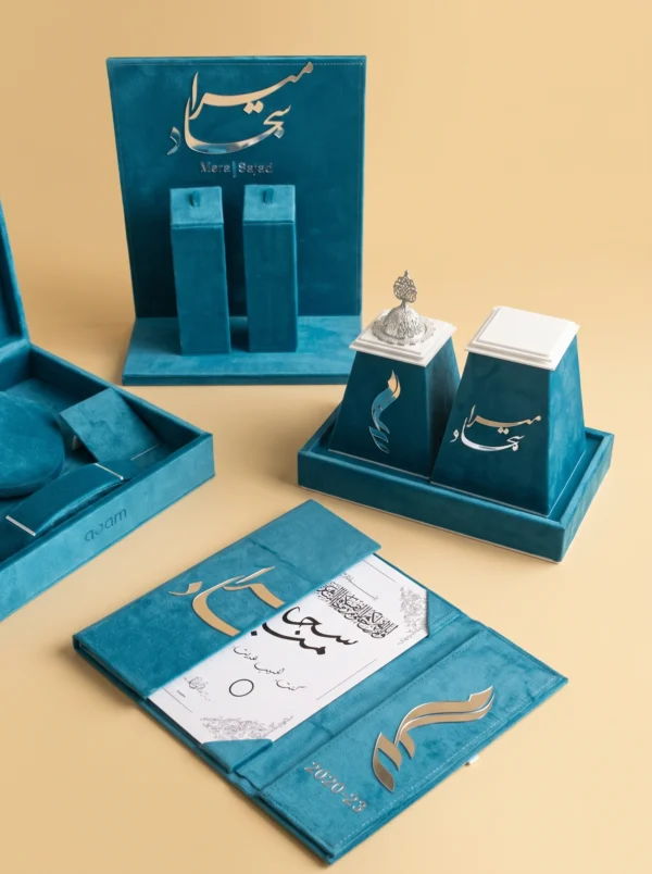 Close-up of couples gifts name plaque and keepsake burners with gold and silver calligraphy detail