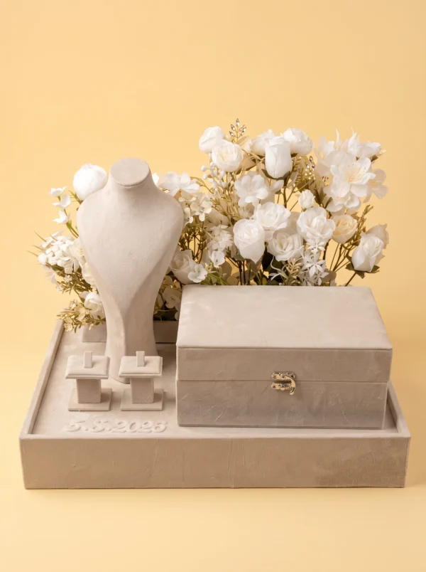 Proposal ring box set with the hinged ivory velvet box closed, gold clasp, bust and ring pedestals