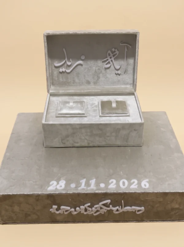 Silver velvet ring box with engraved date on stone-textured base for a US proposal