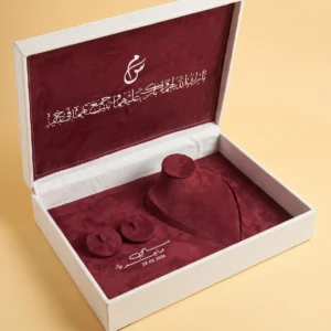 Gift boxes with lids: ivory jewelry box open on burgundy velvet with necklace bust, ring pads and names